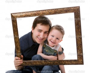 Casual portrait of father and son having fun together playing with frame. Isolated on white